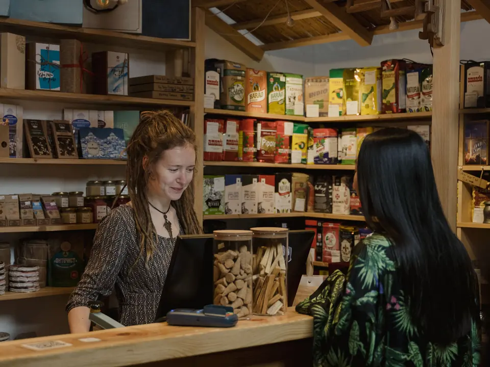 Shop counter with a customer and a sales assistant