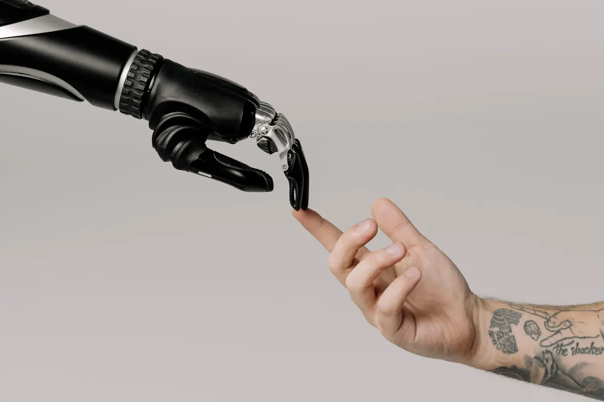 A human hand reaching towards a robotic hand