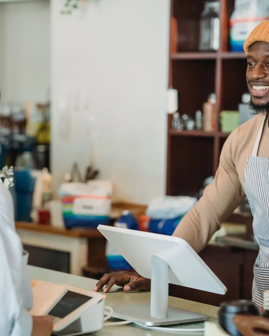 Barista smiling at a customer at the counter